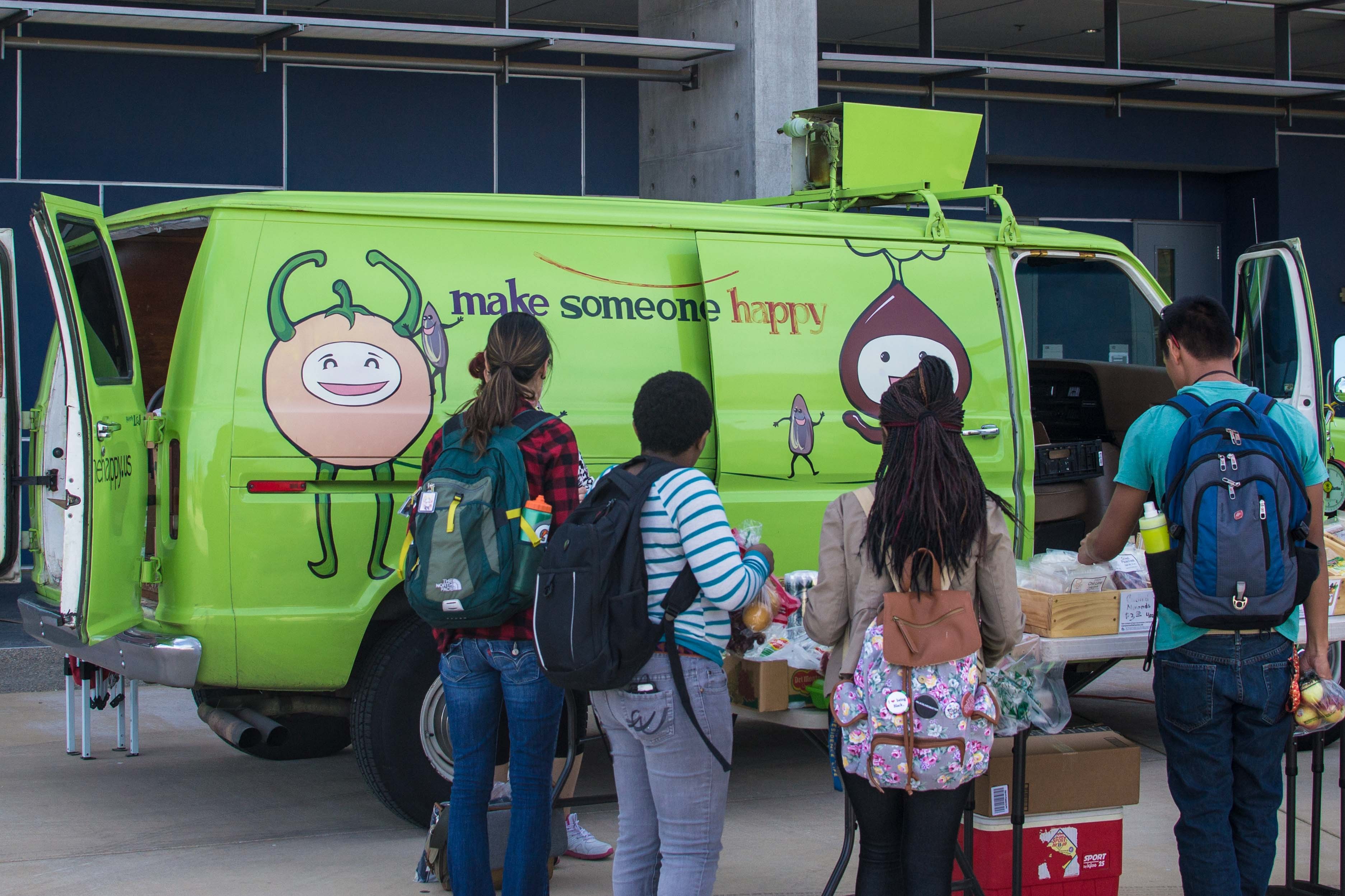 Students stand in front of the food van.